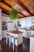 Breakfast counter with bar stools in white kitchen