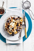 Blueberry and banana waffles with maple syrup