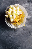 A pumpkin and walnut cupcake with a bite taken out