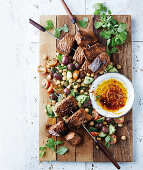 Harissa beef skewers with a chickpea salad