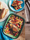 Baked fish with tomatoes, beans and olives