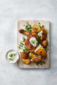Indian style roast chicken with potatoes, peas and a yoghurt dip