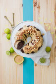 A chocolate custard wreath cake with lime and caramel sauce and almond brittle