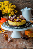 Pumpkin and orange cheesecake with a brownie base and macarons