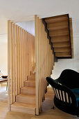 Foot of elegant staircase with wooden balusters in living area