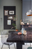 Dining table and classic chair in dining room with dark wall