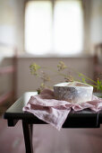 Rustic stoneware bowl on pink cloth