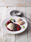 Vanilla and coconut mousse with berry compote and almond biscuits