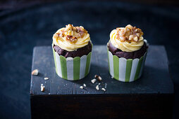 Vegan chocolate cupcakes with vanilla frosting and caramelised almonds