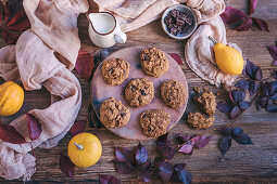 Pumpkin chocolate chip cookies served on a ceramic plate on rustic wooden table