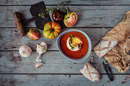 Tomato soup with heritage heirloom tomatoes, cream, baby basil, cracked black pepper and garlic and rustic bread
