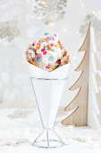 A bubble waffle with frozen yogurt and colourful chocolate sweets for Christmas