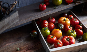 Red and green tomatoes in a crate