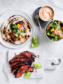 Flank steak tacos with corn, avocado and coriander