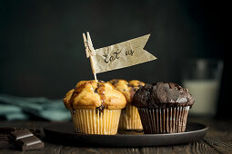 Vanilla and chocolate muffins with chocolate chunks and paper flags