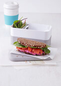 A wholegrain bread sandwich with beetroot cream and salmon (office lunch break)