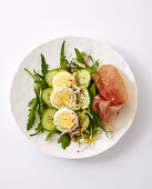 Carpaccio with eggs, rocket, cucumber and ham