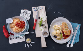 Spaghetti with tomato sauce and pasta with fish fillet, fennel and olives