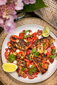 Marinated, grilled sea bass fillets with spicy salsa