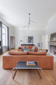 Two leather sofas facing one another in front of open fireplace