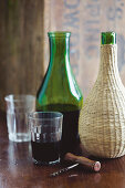 Red wine in a green carafe and a demijohn