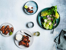 Coal-fired Jamaican chicken wings with radish and butter lettuce salad