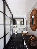 View from the hallway with bench and wall mirror onto the vanity with counter basin