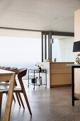 Dining room and open-plan kitchen in modern architect-designed house