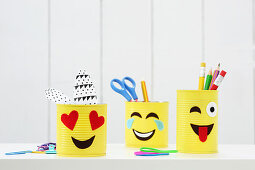Hand-made emoji desk organisers made from tin cans