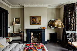 Open fireplace and stucco ceiling in bedroom