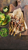 Lamb and rosemary skewers with charred lettuce and braised peas