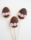 Three Decorated Easter Egg shaped cookies on a stick