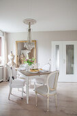 Medallion chairs around dining table in grey-and-white dining room