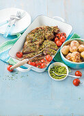 Butterflied lamb with macadamia and spinach pesto