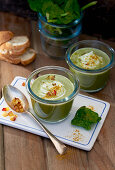 Spinach soup topped with apple in jars