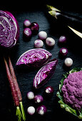 Purple cauliflower, purple cabbage, purple carrots, purple and white pearl onions and eggplant
