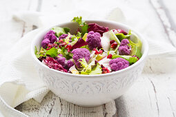 Mixed leaf salad with purple cauliflower, avocado and pomegranate seeds