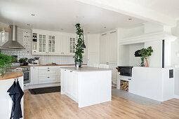 Island counter in white fitted kitchen