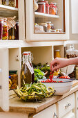 Pickles, fresh fruit and vegetables on a kitchen dresser