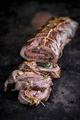 Roast beef roulade filled with chard, sliced
