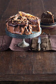 Schokoladenkuchen mit zweierlei Ganache dekoriert mit Schokoriegeln