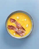 Pumpkin soup with bacon strips