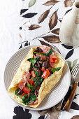 Ham, tomato and olive omelette