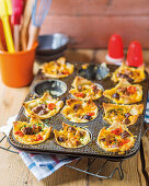 Mini bread quiches with tomatoes, grilled meat and cheese