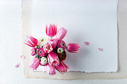 Spring bouquet of pink tulips and ranunculus (top view)