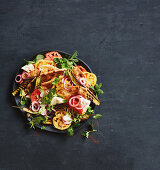 Fattoush salad with grilled aubergines, tomatoes, and onions