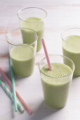 Matcha smoothies in glasses with straws