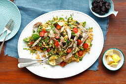 Lentil and spinach salad with smoked mackerel, prunes and cherry tomatoes