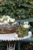 Flower arrangements of ivy berries, onions and carnations