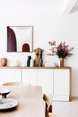 Modern sideboard with sculpture and vases in the dining room